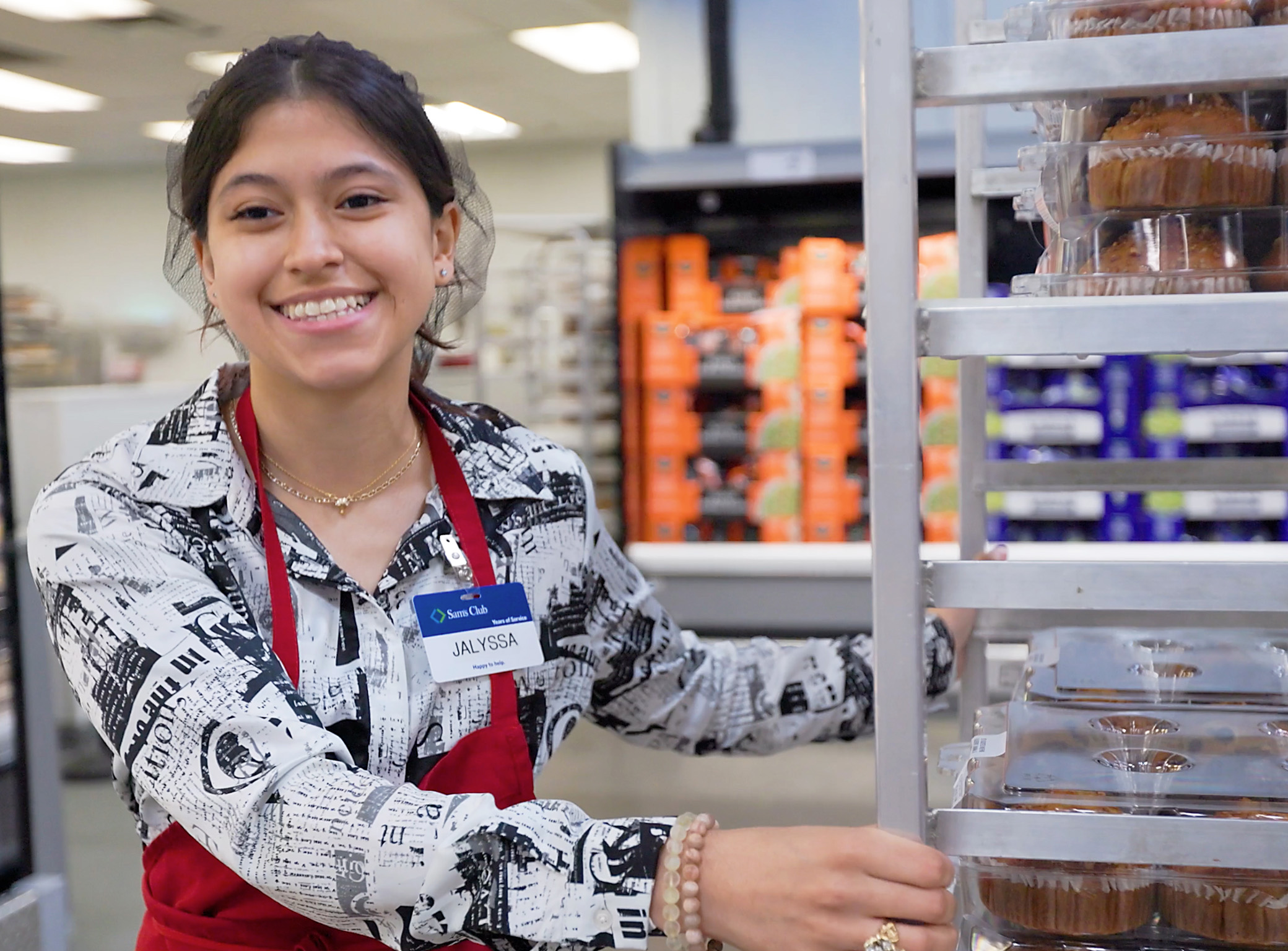 female Sam's Club associate with a bakery cart