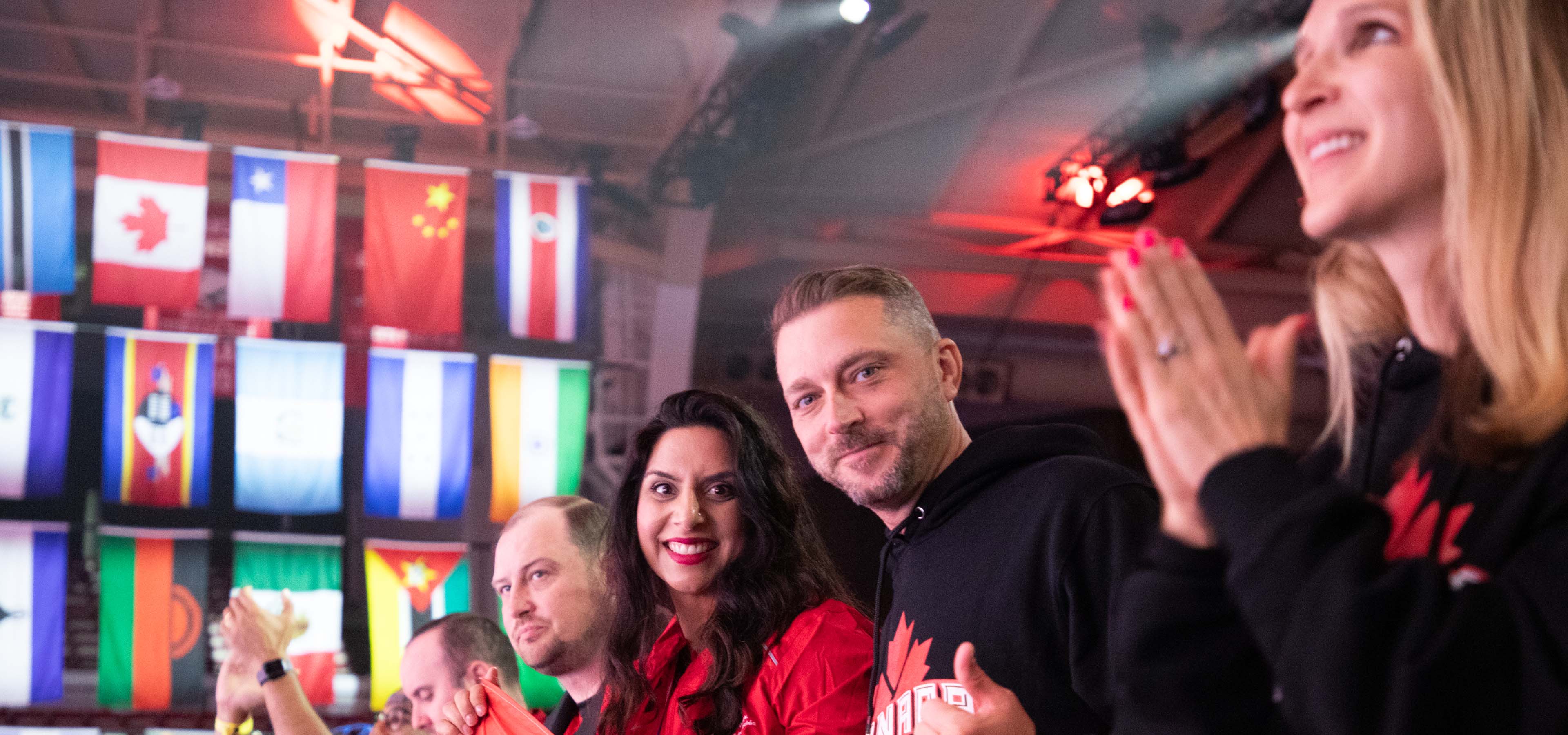 a group of international associates smiling and clapping