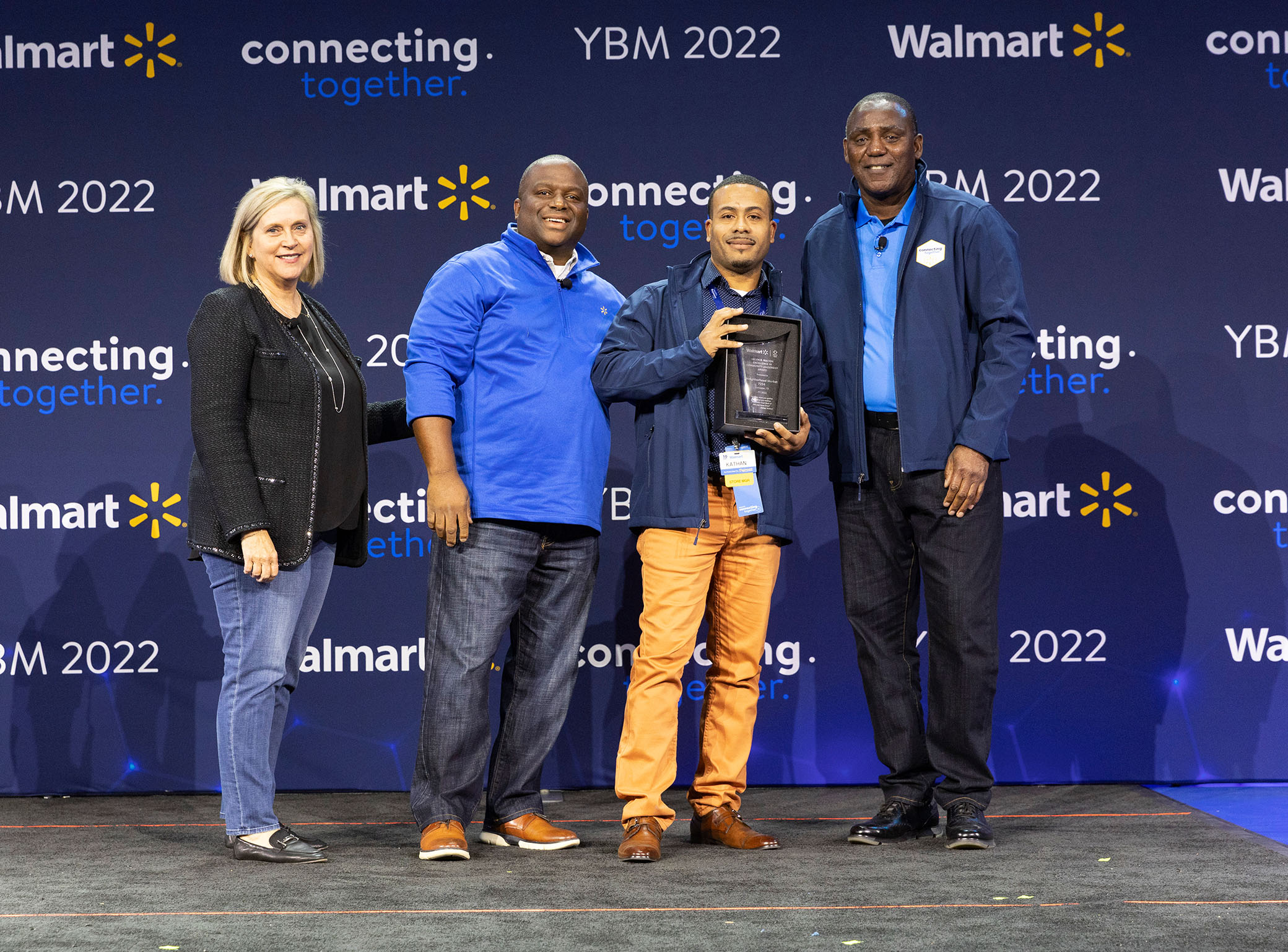 Kathan Morgan receives the Helen R. Walton Excellence in Community Leadership award; he is standing with other Walmart associates.