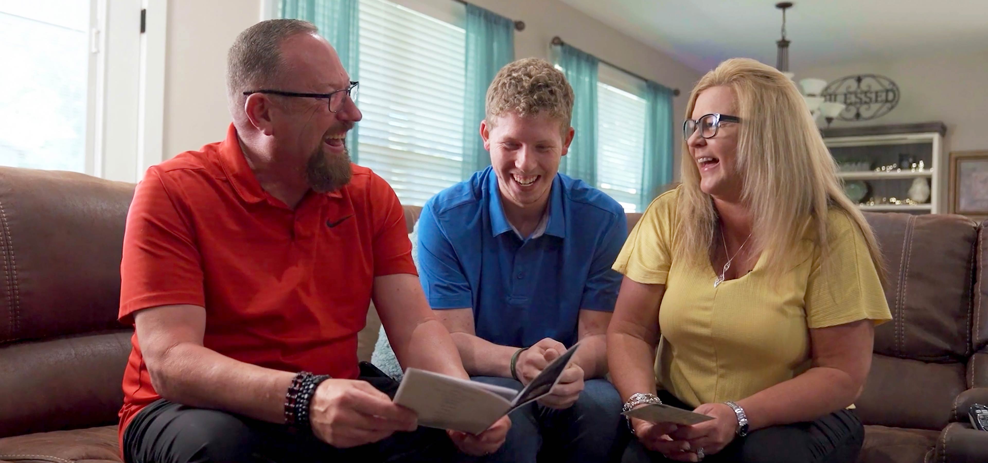 Walmart Store Manager Conner Stevens sits between his parents, Mark and Kim Stevens.