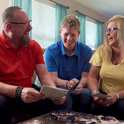 Walmart Store Manager Conner Stevens sits between his parents, Mark and Kim Stevens.
