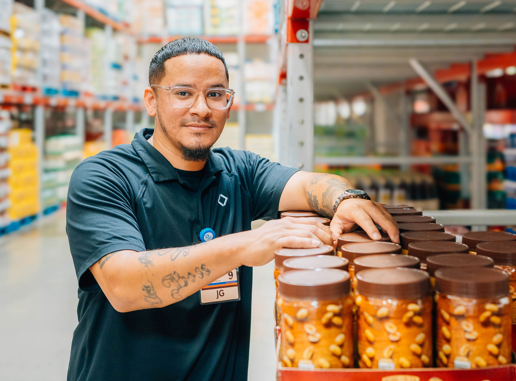 Sam’s Club Manager Justin Garcia looks up from stocking shelves.