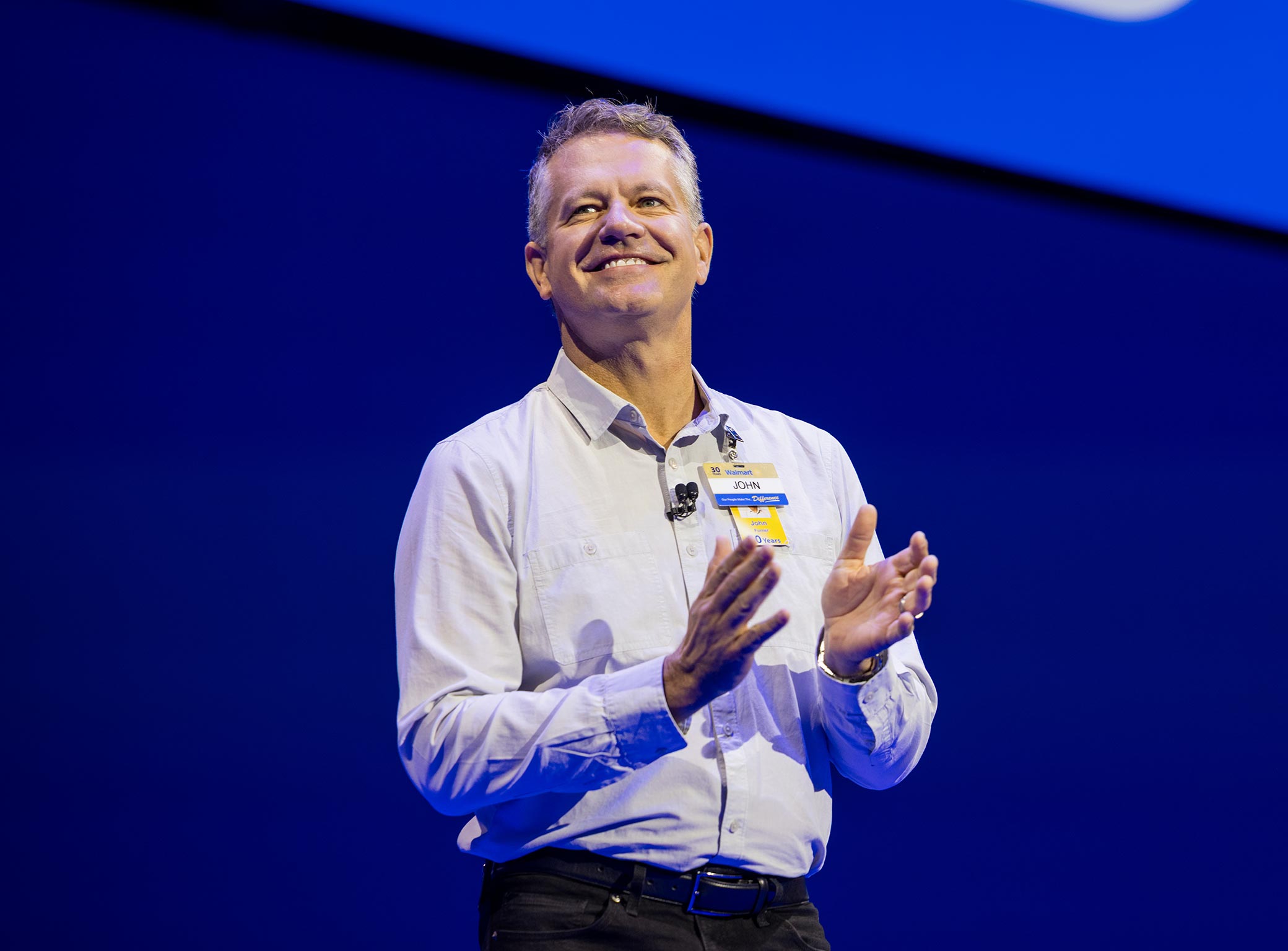 Walmart U.S. CEO John Furner smiles on stage at Associates Week 2025.