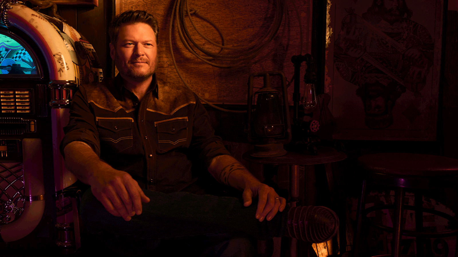 Cover art from Blake Shelton's album, For Recreational Use Only. In an old honky-tonk, with cowboy paintings on the walls, Blake sits in front of a retro jukebox.