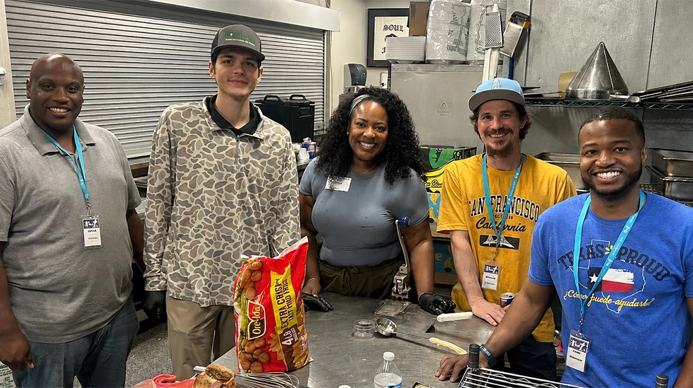 Walmart associates pose together while volunteering with Beautiful Feet Ministries