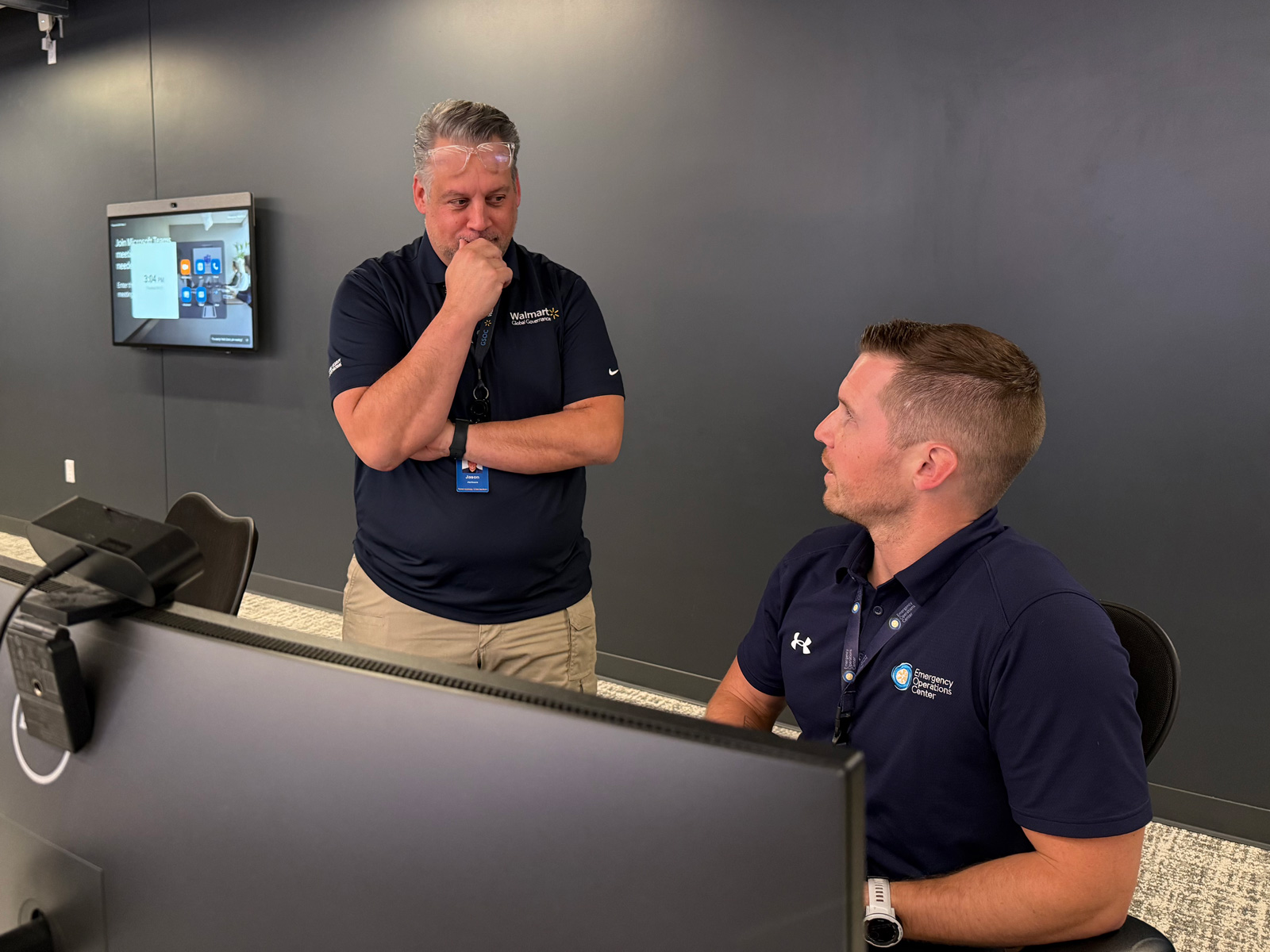 Jason Jackson and Tom Bedard consult on an emergency situation in Walmart's Global Security Operations Center.