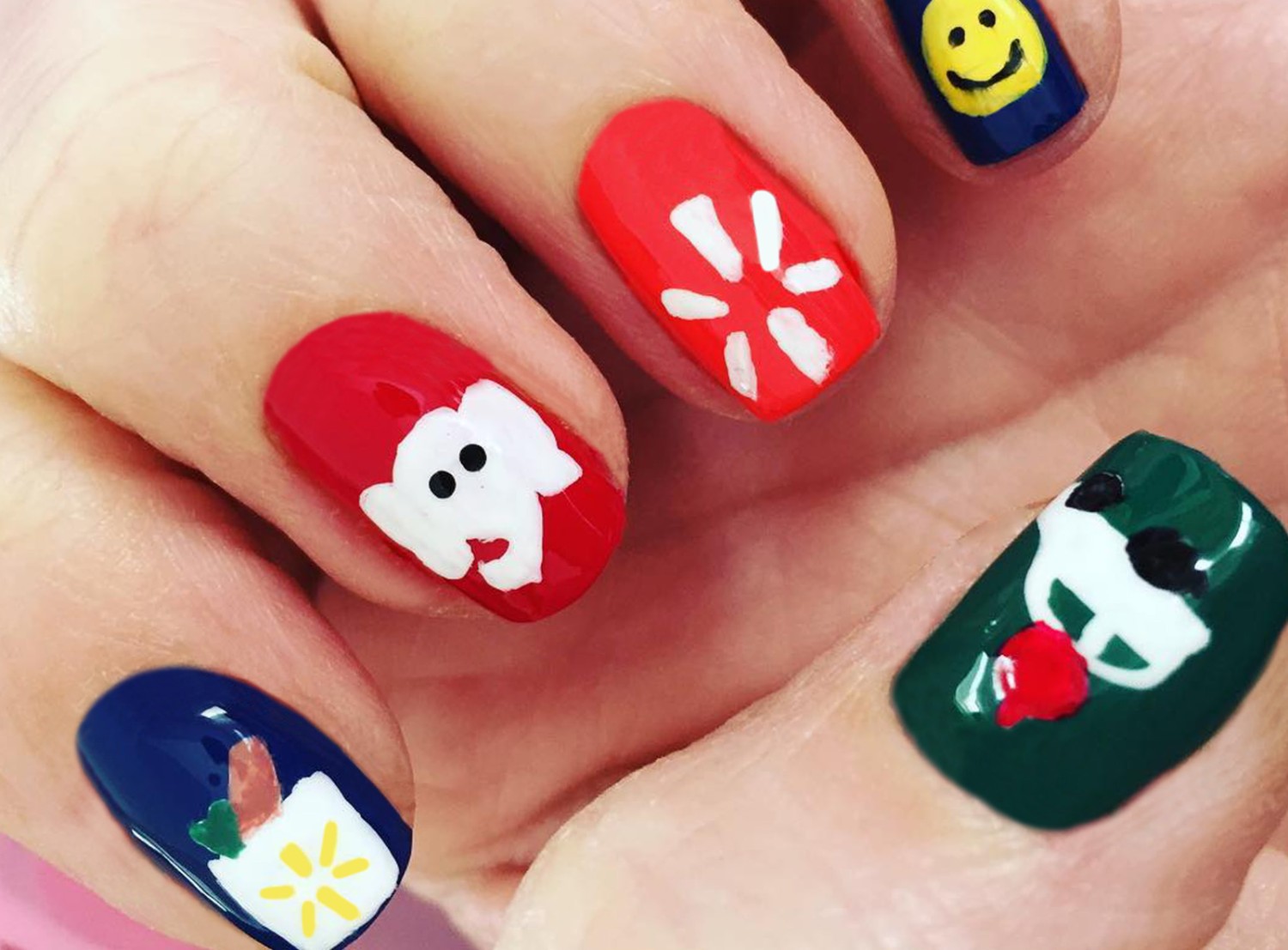 Some of Jenna Sundeen's fingernail masterpieces: Walmart grocery bag, elephant head, Walmart spark.
