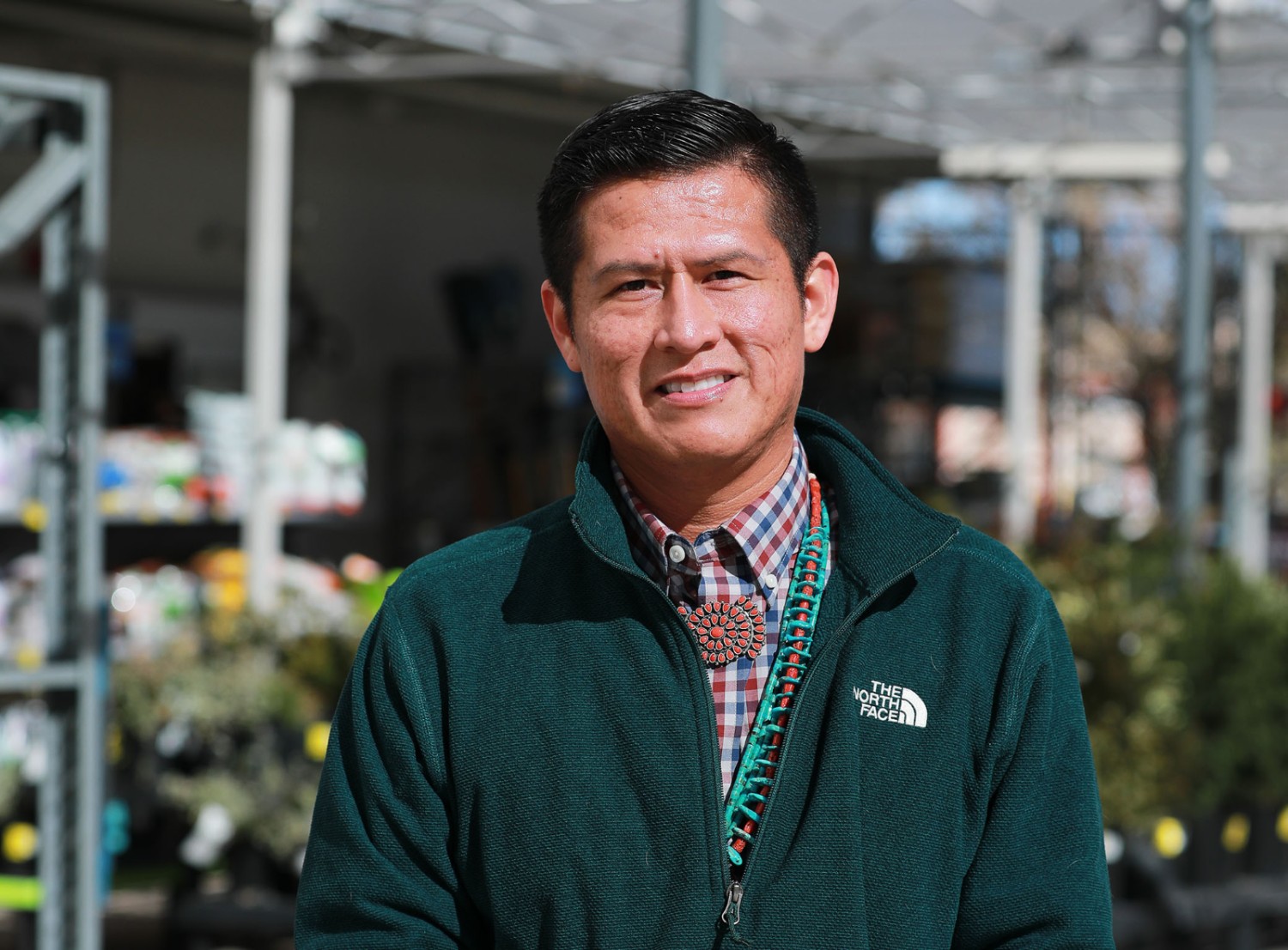 Douglas smiling in front of the camera in the garden section of a Walmart store